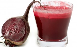 A glass of fresh beet vegetable juice isolated on white background.